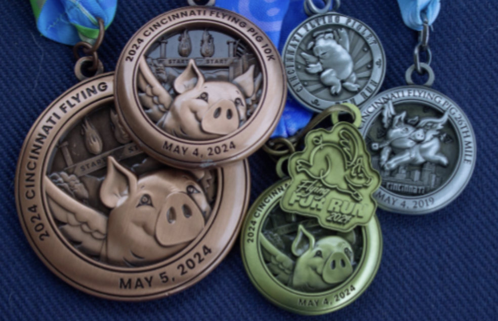The Smith Family displays a few of their Flying Pig medals, won throughout the years.